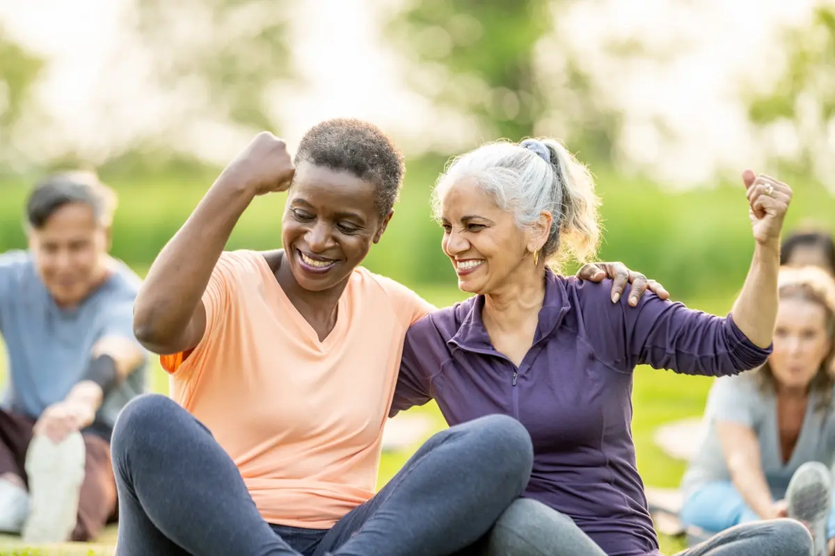 11 Signs It Might Be Time for Assisted Living: seniors smile during outdoor fitness class