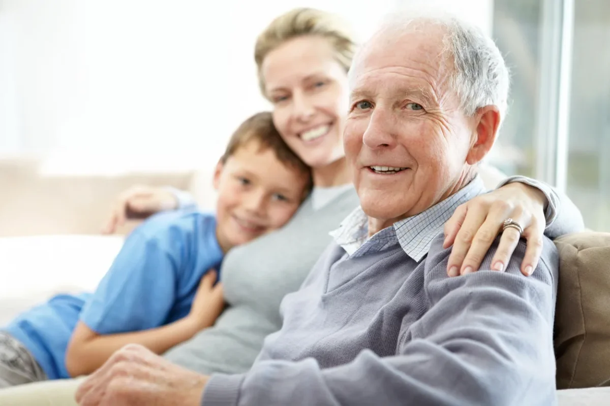 What Is Assisted Living Guide for Southern Oregon Families What is assisted living shown through an older adult spending time with family in a comfortable home-like setting.